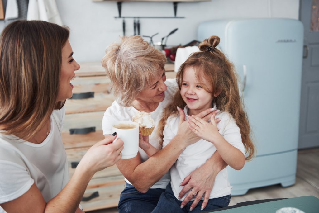 Cheerful people. Mother, grandmother and daughter having good time in the kitchen